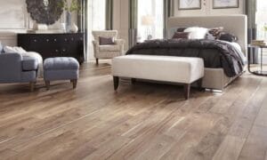Stylish bedroom featuring a comfortable bed, seating area, and wooden flooring.